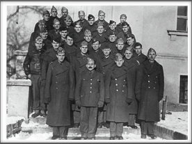 TEXANS - Front l-r:  Col. Doyle Yardley, Col. Charles Jones; 2nd row, 2nd from left behind the Kriegy with the mustache is John R. Rodgers; 2nd row, far right is Roy J. Chappell; 3rd row, 1st on left is Michael Calpin; 2nd from left is Amon Carter; 3rd from left is Harry E. Evans; 4th row, 2nd from left is Leonard W. Spence