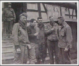 Lt. Col. James W. Lockett, 4th from left, speaking to Capt. Louis Torgeson after escaping from a German prison at Hammelburg, Germany - 4/3/45